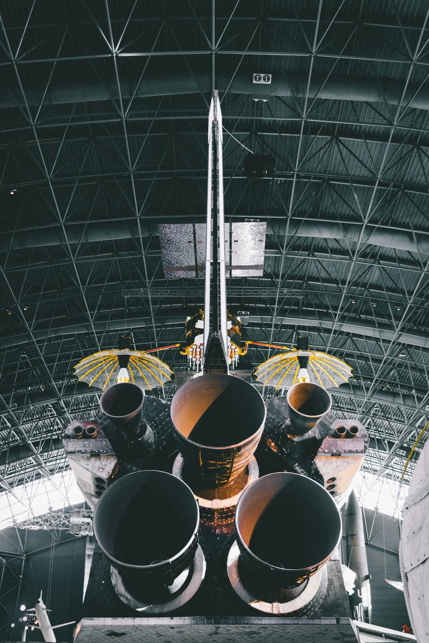 photograph of a still rocketship in a factory from behind